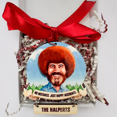 Decorative ornament with a portrait of Bob Ross with a red bow and gift box