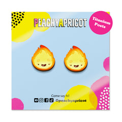 Flame-shaped earrings on a colorful branded card.