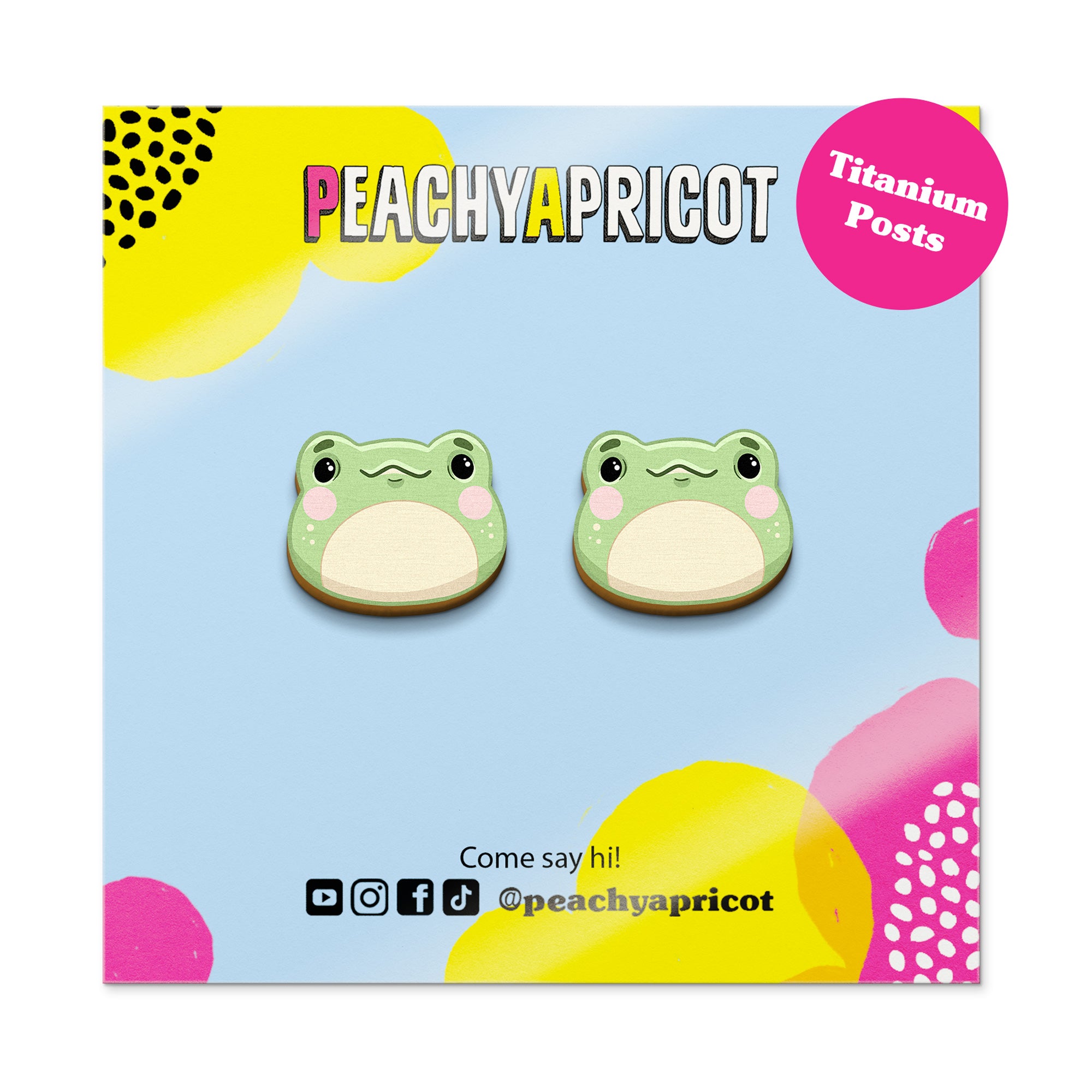 Frog-shaped earrings on a colorful packaging with 'Peachy Apricot' branding.