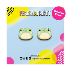 Frog-shaped earrings on a colorful packaging with 'Peachy Apricot' branding.