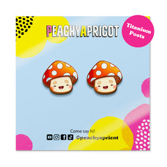 Cartoon mushroom earrings on a colorful background with 'Peachy Apricot' branding.