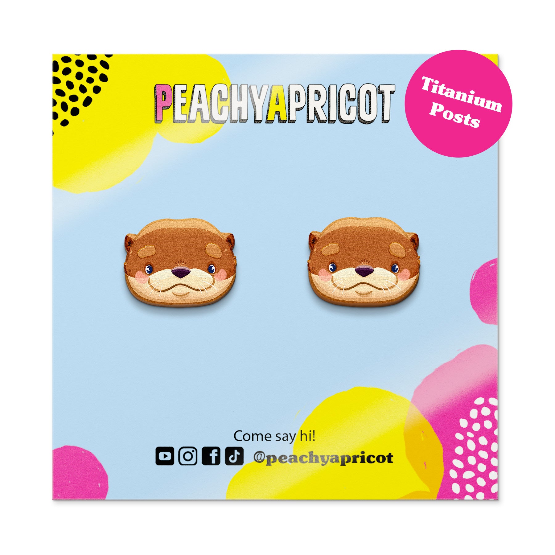 Peachy Apricot otter-shaped earrings on a colorful packaging background