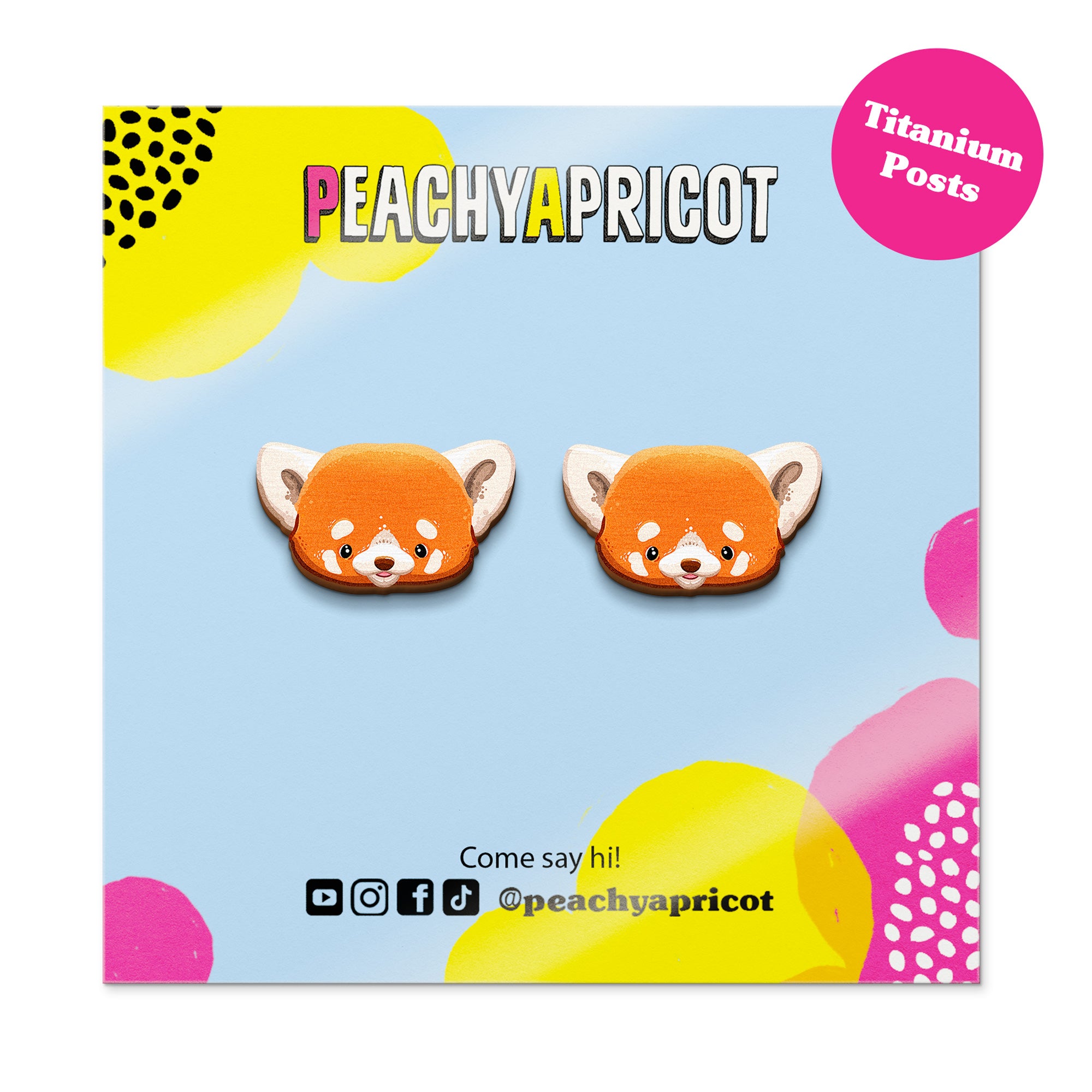 Peachy Apricot fox-shaped earrings on a colorful branded card