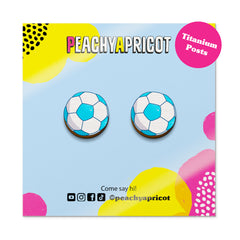 Soccer ball earrings on a colorful 'Peachy Apricot' branded card with social media handles.