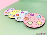 set of 4 board game inspired coasters with meeples printed all over them in different colors